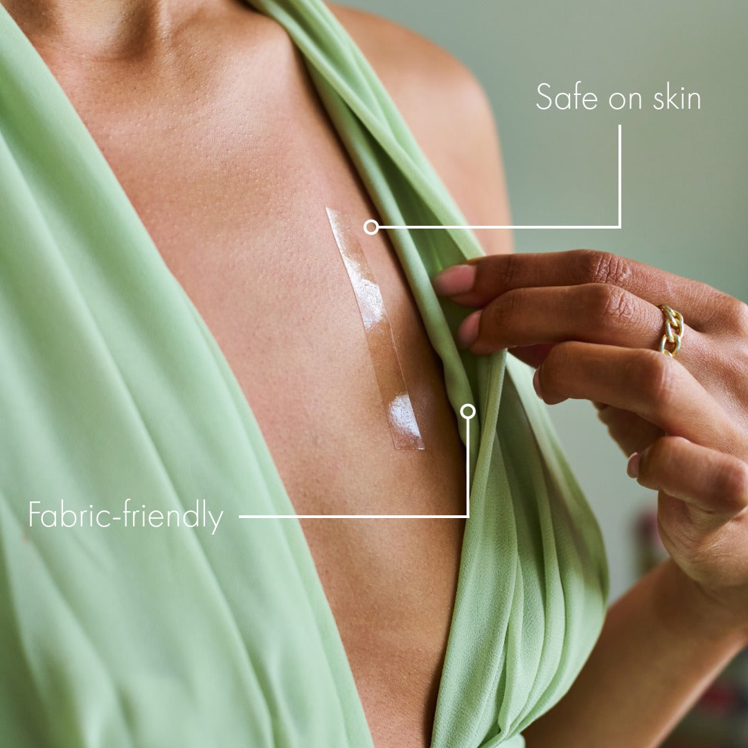Picture of girl securing dress in place with double sided tape