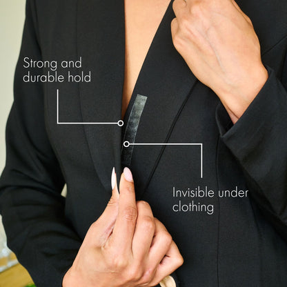 Girl securing shirt with double sided tape demonstrating that it is Invisible under clothing